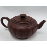 A Chinese Yixing ovoid fluted lidded teapot, impressed mark to lid, width 17cm (lid AF).