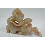 A Chinese celadon green and pink flecked jade carving of a deer with peach branch, length 9.5cm.