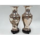 A pair of Chinese silver plated baluster vases, decorated with a woman in a trellis garden to one