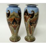 A pair of Royal Doulton stoneware tall baluster vases with incised stylised foliate decoration,