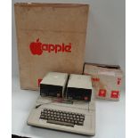 An Apple II Europlus computer, together with two disc drives and original cardboard casings for