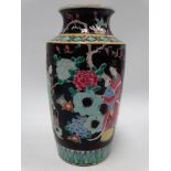 A Chinese famille noir vase decorated with three ladies amongst rocks issuing flowers, four