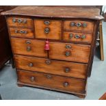 A late 18th or early 19th century red walnut chest of eight drawers with serpentine shaped top