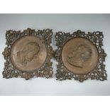 A pair of Victorian cast bronze wall plaques within a lozenge strapwork foliate scroll pierced