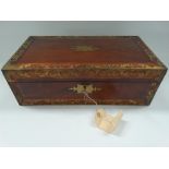 A 19th century mahogany brass inlaid writing slope, hinged to reveal a leather gilt tooled inset and