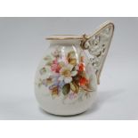 A Royal Worcester vase with reticulated floral scroll moulded single handle, No.1137, puce printed