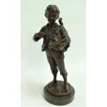 A bronze model of a busker boy with a violin at his shoulder and a hat full of coins, after