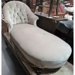 A late 19th century day bed with upholstered single end raised on four ebonised turned legs.