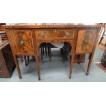 An early 19th century Sheraton style sideboard, the bow front fitted a pair of doors and single