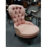 A Victorian mahogany and upholstered occasional chair with button back and pink upholstery.