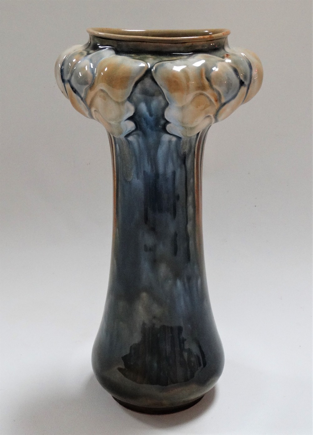 A Doulton Lambeth Art Nouveau vase, the bulbous moulded top with stylised frond design upon a