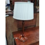 A turned mahogany electric lamp base.