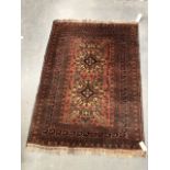 A modern middle eastern rug, the centre with two lozenge medallions amongst foliate motifs and