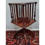 A mahogany and inlaid revolving bookcase on turned and carved stand.