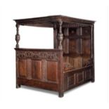 An Anglo Dutch oak panelled bed, 17th century and later with foliate strapwork detail overall, the