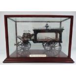 A model of a horse drawn hearse within glazed case and with ivorine label inscribed 'Mors Omnibus