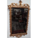 A mid 18th century carved giltwood wall mirror, possibly Irish, the rear carved with maker's mark