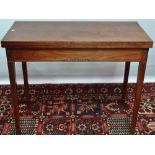 A George III mahogany and strung tea table with square section tapering legs and banded inlays,