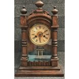 A late 19th century walnut cased mantle clock with mercury filled pendulum, height 45cm.