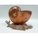 A copper nautilus shell spoon warmer with a naturalistic base, width 19cm.