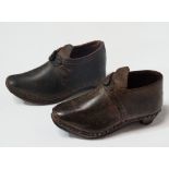 A pair of Victorian child's leather, wood and metal mounted clog style shoes, width 13cm.