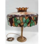 A Tiffany style Miller ML Co. 236 lamp fitted a slag glass leaded shade with vine decoration,