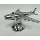 A Dunhill chromium plated table lighter in the form of an aeroplane, the nose of the plane presses