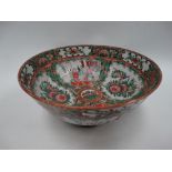 A Chinese famille rose bowl decorated with panels of figures within interiors and foliage with