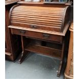 A Victorian oak tambour front bureau with pigeon holes and single drawer over a frieze drawer and on