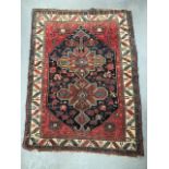 An antique Caucasian Bergama style rug with two central lozenge lobed medallions amongst animal