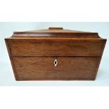 A good Georgian rosewood boxwood inlaid sarcophagus form tea caddy, the hinge lid revealing a fitted