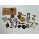 A WWII Defence medal awarded to W.J. Dutton within box, together with various badges, including