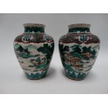 A pair of Chinese famille verte ovoid vases decorated with mountainous lake landscapes with