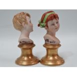 A pair of modern Capodimonte miniature busts of children upon gilded pedestals, both signed B.