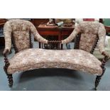 A late 19th century twin seater sofa with button back upholstery and spiral turn framed structure