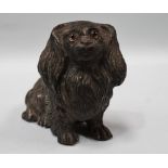 A silver plated spelter pin cushion in the form of a Pekinese dog with glass inset eyes, width 6cm.