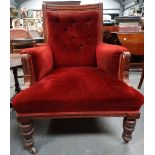 A late 19th century walnut framed salon armchair with turned legs and button back upholstery.