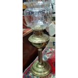 A brass oil lamp with clear glass shade, height including shade 58cm.