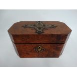 A Victorian burr walnut veneered rectangular tea caddy with canted corners, the lid with brass