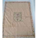 A mid century silk embroidered cotton bed throw with central inscription amongst foliate scrolls '