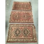 Three similar middle eastern rugs, each 129 x 82cm.