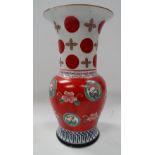 A Japanese famille verte baluster flared neck vase painted in enamels with foliate roundels and