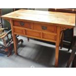 A Chinese hardwood side table of tapering form fitted with two drawers, width 117cm.