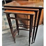 A nest of three mahogany and inlaid Edwardian tables.