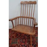 A late 18th or early 19th century high comb back Windsor armchair, with two part bow back, mixed