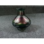 An Art Nouveau Loetz style iridescent green glass vase, the bulbous body with stylised trailed