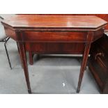 An early 19th century mahogany and banded folding tea table on square section tapering legs, width