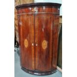 A George III mahogany and inlaid bow front hanging wall cupboard with shell patera inlay, height