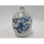 A Japanese porcelain blue and white underglazed ovoid bud vase, foliate decorated, height 11cm.