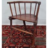 An early West Country or Welsh stickback armchair in ash and elm with traces of original red
